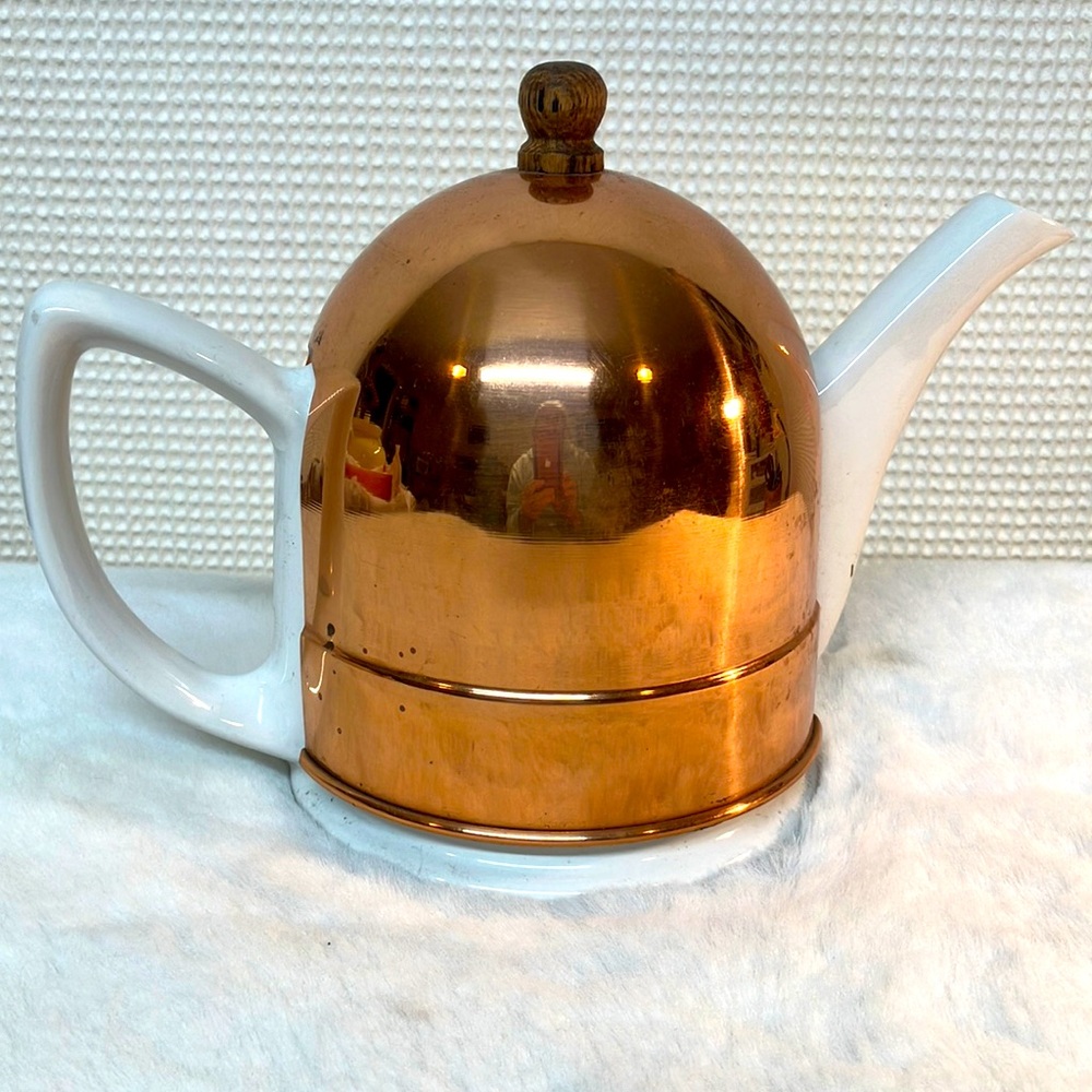 Ceramic teapot with copper cozy